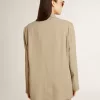 Beigefarbene Damenjacke mit Nadelstreifen und einreihiger Knopfleiste in Oversize-Passform Beigefarbene Damenjacke mit Nadelstreifen und einreihiger Knopfleiste in Oversize-Passform