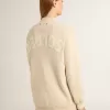 Beigefarbene Damenstrickjacke mit „Golden”-Schriftzug auf der Rückseite Beigefarbene Damenstrickjacke mit „Golden”-Schriftzug auf der Rückseite