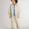 Beigefarbene Kinderjacke mit bunten Sprenkeln Beigefarbene Kinderjacke mit bunten Sprenkeln