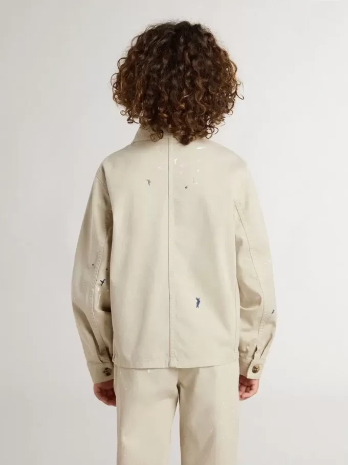 Beigefarbene Kinderjacke mit bunten Sprenkeln Beigefarbene Kinderjacke mit bunten Sprenkeln