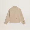 Beigefarbene Kinderjacke mit bunten Sprenkeln Beigefarbene Kinderjacke mit bunten Sprenkeln
