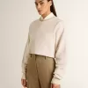Cremefarbenes, kurz geschnittenes Sweatshirt für Damen aus Baumwolle mit Kristallen auf der Vorderseite Cremefarbenes, kurz geschnittenes Sweatshirt für Damen aus Baumwolle mit Kristallen auf der Vorderseite