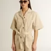 Damen-Jumpsuit aus beigem Denim mit Gürtel und ausgefranstem Saum Damen-Jumpsuit aus beigem Denim mit Gürtel und ausgefranstem Saum