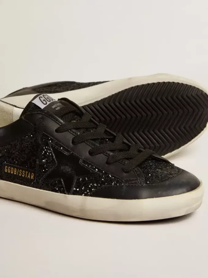Damen-Superstar aus schwarzem Nappa und Glitzer mit glänzendem schwarzen Lederstern Damen-Superstar aus schwarzem Nappa und Glitzer mit glänzendem schwarzen Lederstern