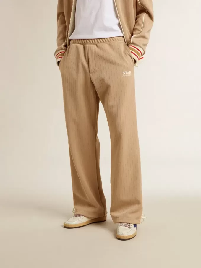 Hellbeige Jogginghose für Herren mit weißem Logo Hellbeige Jogginghose für Herren mit weißem Logo