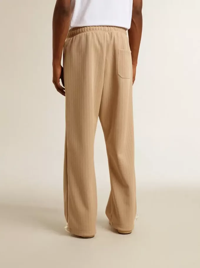 Hellbeige Jogginghose für Herren mit weißem Logo Hellbeige Jogginghose für Herren mit weißem Logo