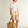Herren-Poloshirt aus weißem, perforiertem Strick mit burgunderfarbenen Streifendetails Herren-Poloshirt aus weißem, perforiertem Strick mit burgunderfarbenen Streifendetails