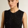 Schwarzes Mesh-Strickoberteil mit Pailletten und kontrastierenden Details